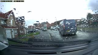 Drving along the pavement outside a school.  Dashcam.