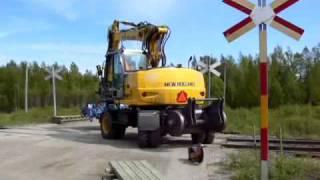 New  Holland excavator on railroad