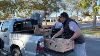 Attorney David Marshall and young helpers load 30 frozen donated turkeys for Orangeburg's Samaritan