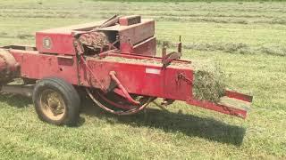 Antique number 9 Massey Ferguson square baler in the  field working