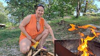Wood cutting  Mila. cooking on an open fire. Mila's Naturist Cooking. Mila naturist.
