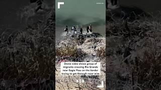 Drone video shows group of migrants crossing Rio Grande trying to get through razor wire