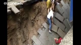 Sinkhole opens in pedestrian street, swallows 2, china