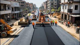 Amazing Gravel paving machinery with construction workers and equipment actively working on the road