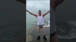 irish traveller man jumps in the cold irish Sea