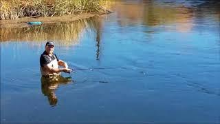 Fishing in Stream Wading Waders Jigging for a Fish in Bishop CA California Vacation