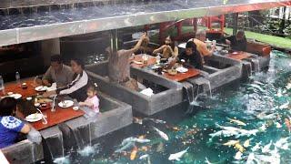 Amazing restaurant built inside a carp fish pond in Thailand