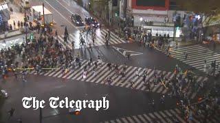 Japanese fans run across Tokyo's Shibuya crossing in celebration of World Cup win