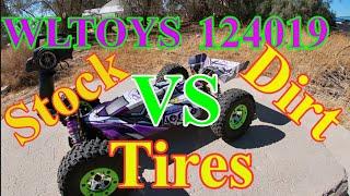 WLTOYS 124019 stock tire vs off-road tires on a track.