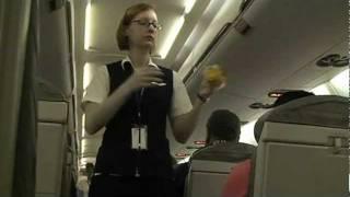 Sexy stewardess explains emergency procedures.