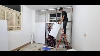 The construction of a wall closet by a young couple