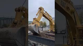 Excavator CAT 245B me loading truck on a basement