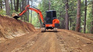 Stumps, slopes and road with the Kubota KX-040