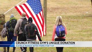 Roanoke gym members run 5.8 miles while carrying donations on their backs