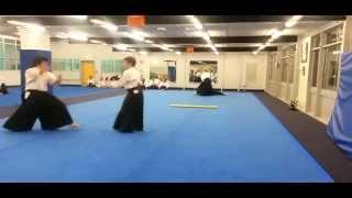 Aikido adults doing taninzugake - Tanto tori (in foreground), Bokken tori (in background)