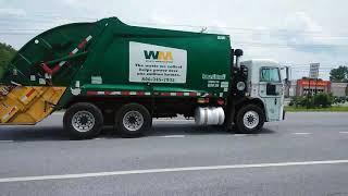 Small rear loader waste management truck