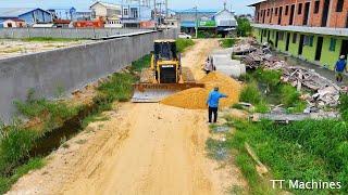 Power Stroger Heavy Shantui Dozer Working On Site Removal Clearing Mud Stone Into Water & Dump Truck