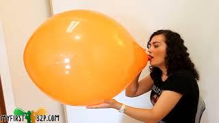 Emily blow to pop big orange balloon