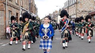 Drum Majors flourish during Huntly Pipe Band's 70th anniversary parade , Scotland, Sept' 2018