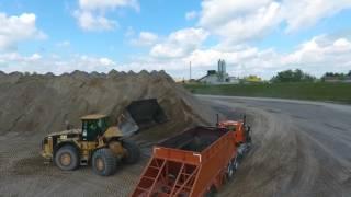 Caterpillar 980G Loading Belly Dump Trailers at a Sand and Gravel Pit