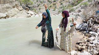 Fishing in the raging river by a young nomadic woman