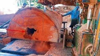 band saw.  Meranti red stone sawing process using a band saw