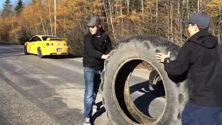 Rolling a giant tire down the road