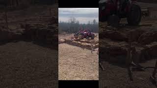 Using a grapple to place the larger rocks making a raised garden bed. #homestead  #grapple