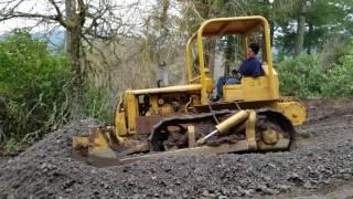 Caterpillar D4 7U dozer pushing gravel