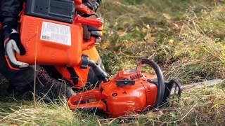 Flip up tank cap on a Husqvarna chainsaw