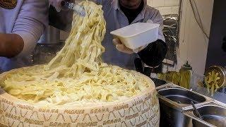 Hand Made Pasta Fettuccine Drowned in a Cheese Wheel. Italian Street Food in London Camden Town