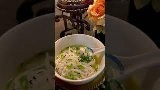 Japanese miso soup with tofu,bok choy,seaweed,and mushrooms,topped with rice noodles & sesame seeds