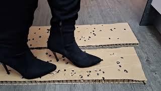 Making holes on cardboard with high boots