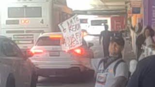 LAX employees call the LAX airport police for a passenger holding a Sign