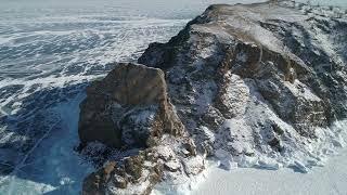 Aerial orbital shot of cape khoboy olkhon island tall rocks in frozen lake baikal