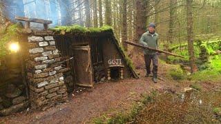 Building a secret shelter in the woods ,clay brick fireplace inside ,primal shelter