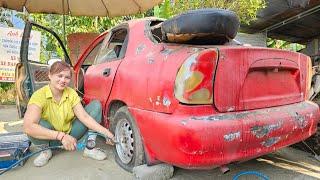 The girl repairs and maintains cars purchased from a pile of scrap.