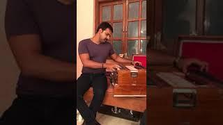 Pawan singh while playing harmonium