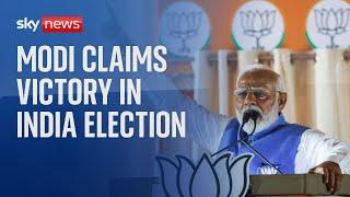 India election: Narendra Modi claims victory for his coalition - but party likely short of majority