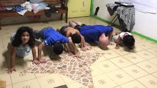 Kids doing push ups with brother Aaron Earnest