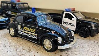 Various Diecast Police Cars Being Driven By Hand On Windowsill