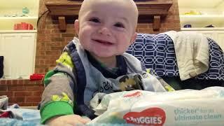 Cute Baby is Easily Entertained by Crinkly Wipes Package