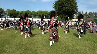 Drum Majors march off the massed Pipes and Drums ending 2023 Oldmeldrum Highland Games in Scotland