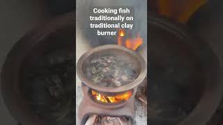 Cooking fish traditionally on traditional clay burner using wood  #fish #cooking #clay #burner