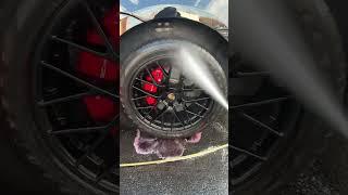 Cleaning brake dust off Porsche rim. Luxury car detailing. Iron remover for rims.