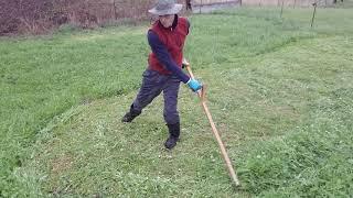 Scythe mowing in the rain.