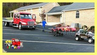 Towing The  Rollback With His Powered Ride On Dodge Ram Two Car Trailer