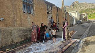 Washing the carpets of the house by Farida Khanom and her children