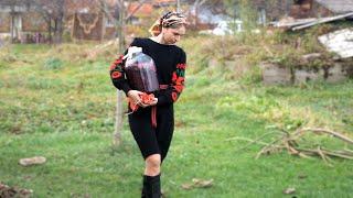 A woman is making traditional homemade wine from 7 kinds of berries.Decorating smokehouse in village