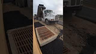 Placing hot fresh asphalt for a brand new road